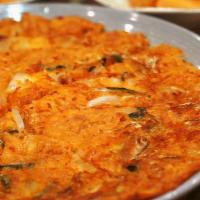 39. Kimchi Pancake · Spicy. Vegetarian. Korean style of pizza/pancake, primarily made with Vegetables & sliced ki...