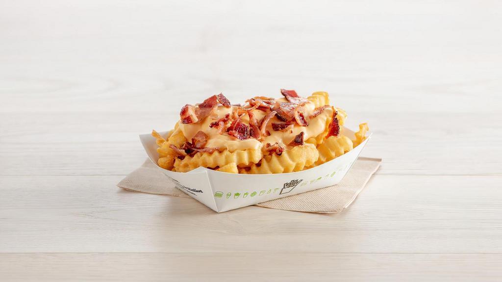 Bacon Cheese Fries · Topped with our cheese sauce and applewood-smoked bacon (contains soy and milk)
