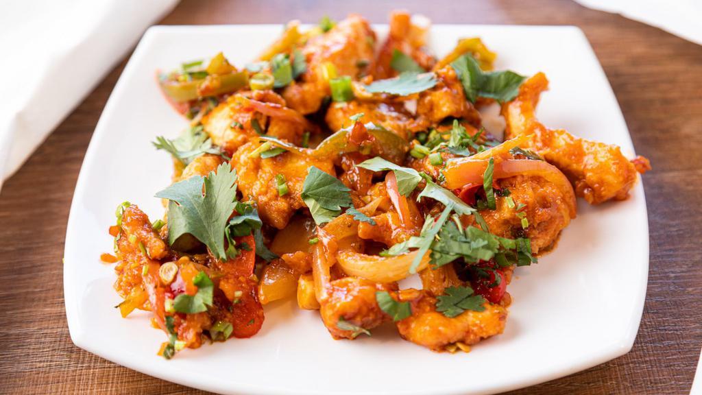 Chilli Chicken · Lightly battered crispy chicken chunks tossed in a spicy chili sauce.