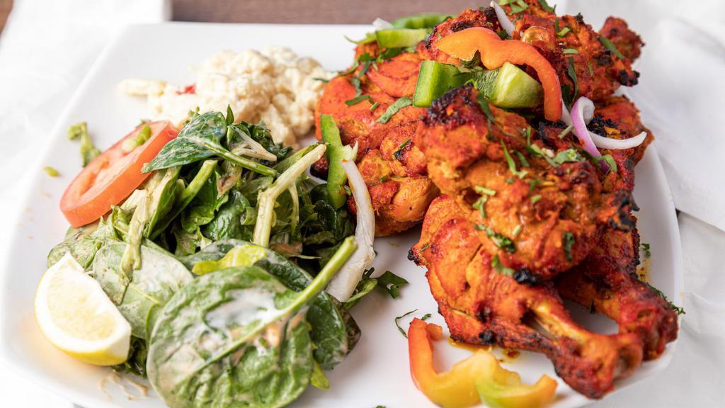 North Indian Tandoori Chicken Legs · Chicken legs marinated overnight in yogurt and spices roasted in clay oven.