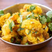 Aloo Gobhi · Popular Indian dish fresh cauliflower and potato cooked with onions, tomatoes, and spices.