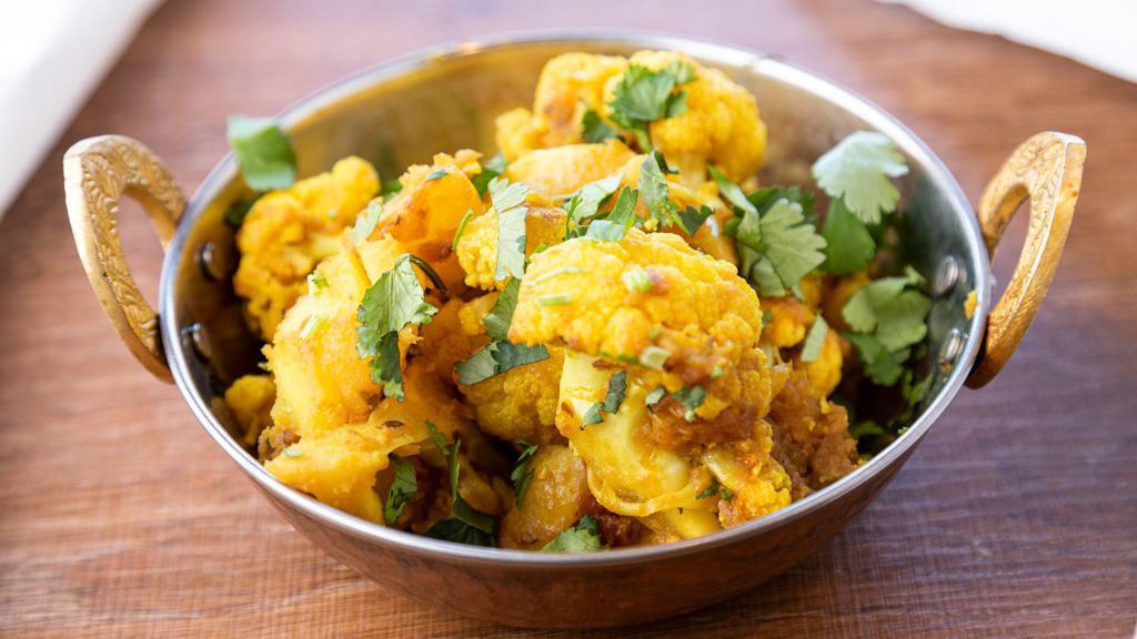 Aloo Gobhi · Popular Indian dish fresh cauliflower and potato cooked with onions, tomatoes, and spices.