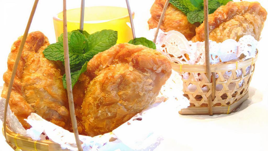 10. Curry Puff · Deep-fried pot sticker sheet stuffed with potato, onion, yellow curry served with peanut sauce and cucumber salad.