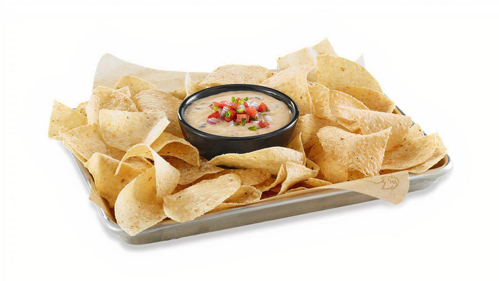 Hatch Queso · MELTED WHITE CHEDDAR / YOUNG GUNS HATCH CHILES / HOUSE-MADE PICO DE GALLO / HOUSE-MADE TORTILLA CHIPS / MAKE IT WILD™: ADD A WILD SAUCE DRIZZLE FOR NO CHARGE