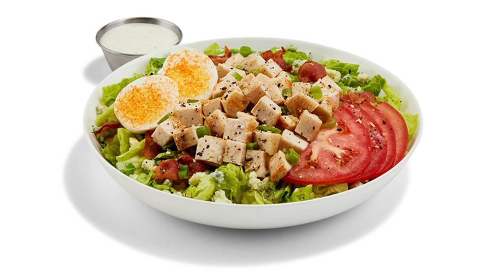 Chopped Cobb Salad · PULLED CHICKEN / ROMAINE LETTUCE / TOMATOES / BACON / HARD-BOILED EGG / RANCH DRESSING / BLEU CHEESE CRUMBLES / GREEN ONIONS / BUFFALO SEASONING / EVERYTHING SEASONING