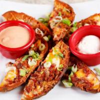Potato Skins · Baked to a crisp, then topped with Cheddar cheese, bacon and green onions. Served with sour ...
