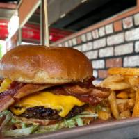 Western Burger · 1/2 lb burger on brioche bun dressed with bacon, fried onion strings, pickles, tomato and le...