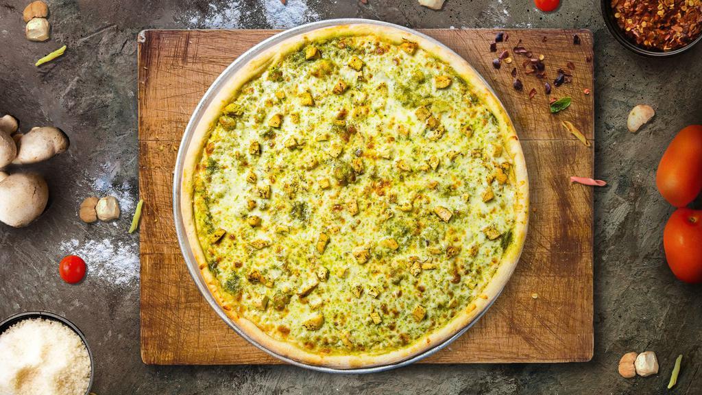 Cluckin' Manipesto Pizza · Creamy pesto garlic sauce on our tuscany thin crust, topped with mozzarella cheese, all-natural grilled chicken, green olives, marinated artichoke hearts, and feta cheese.