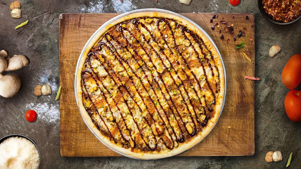 Strippin Supreme Cluck Pizza · Signature garlic white sauce on our original crust, topped with mozzarella and cheddar cheeses, all-natural grilled chicken, smoked bacon, fresh roma tomatoes, and red onions.