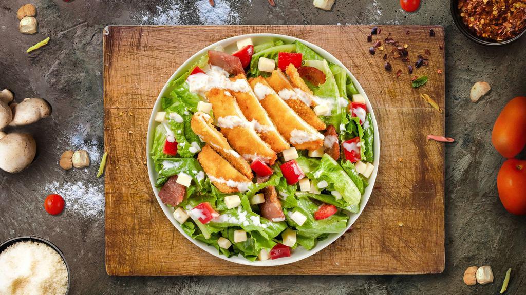 Crispy Cluck Salad · Iceberg lettuce, crispy chicken tenders, red onions, fresh Roma tomatoes, cheddar cheese, mozzarella cheese, seasoned croutons, bell peppers, and black olives tossed with your choice of dressing.