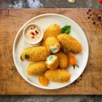 Poppin' Peno · Fresh jalapenos coated in potatoes, filled with cheddar cheese, and fried until golden brown...