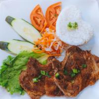 31. Cơm Sườn Nướng · Grilled bone-in pork chop served with steamed rice.