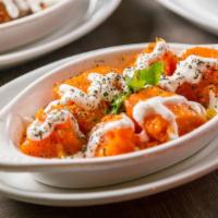 Borani Kadoo · Butternut pumpkin cooked with garlic, peppers and onions topped with special homemade yogurt.