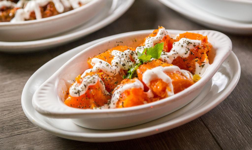 Borani Kadoo · Butternut pumpkin cooked with garlic, peppers and onions topped with special homemade yogurt.