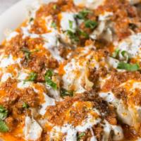 Mantoo Entree · Afghan style potstickers filled with seasoned ground beef, topped with ground beef sauce and...