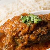 Korma Lamb · Lamb shank cooked with fresh tomatoes and garlic served with white rice.
