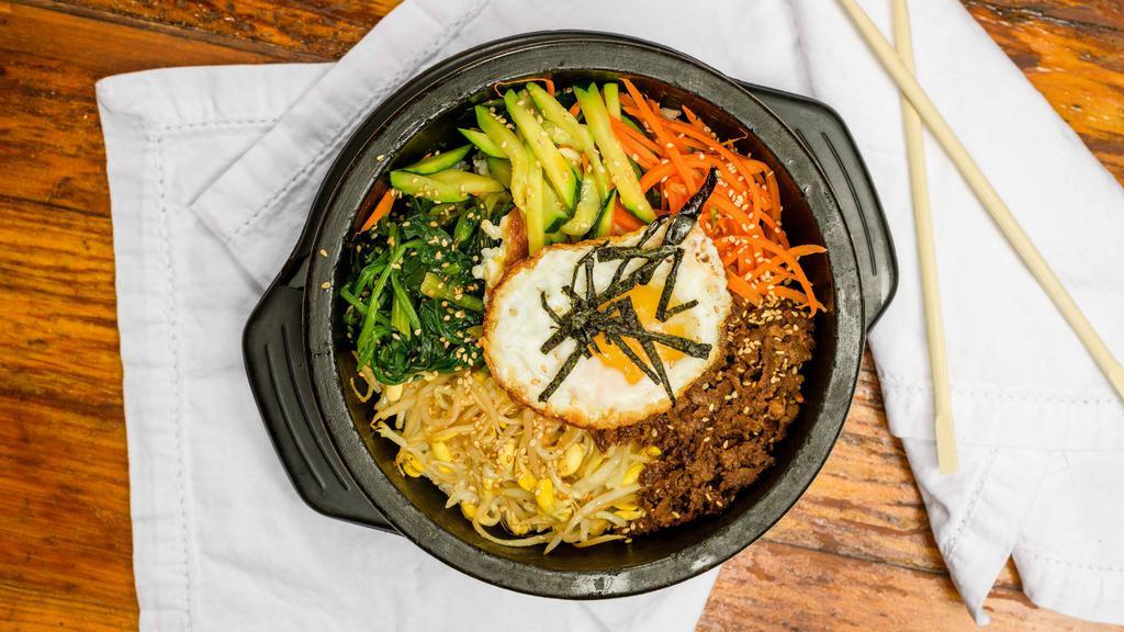 DolSot BiBimBap(돌솥비빔밥) · Mixed Rice topped with beef, vegetables, and egg. Cooked in a hot stone bowl