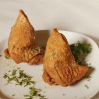 Vegetable Samosas · Potatoes and green peas with mixed Indian spices and wrapped in a golden crispy pastry.