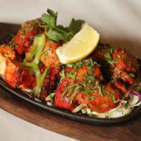 Tandoori Chicken · Tender chicken with bone. Marinated in yogurt, garlic, spices and cooked in a clay oven.