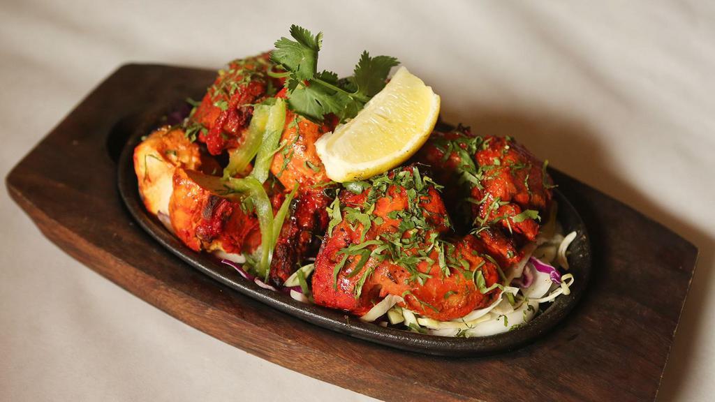 Tandoori Fish · Fish marinated with house spices cooked in clay oven.