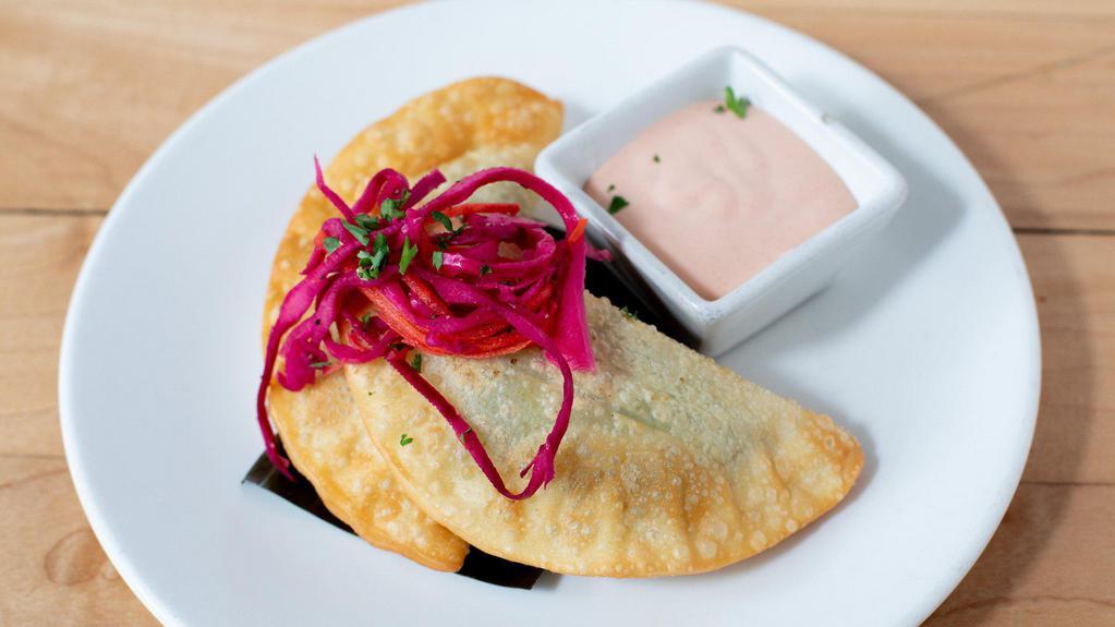*Empanadas · savory crispy pastry filled with your choice of filling (veggie, chicken or beef) and served with our popular spicy sriracha aioli (3 pieces)