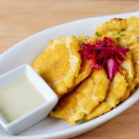 *Tostones - Savory Green Plantains  · smashed crispy fried green plantains served with garlic citrus sauce (mojo de ajo) (gluten f...