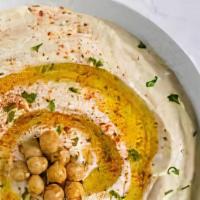 Hummus · A smooth thick mixture of mashed chickpeas, tahini, oil, lemon juice, and garlic.