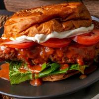 Buffalo Chicken Burger · Delicious buffalo marinated chicken patty with lettuce, onions, and tomatoes.