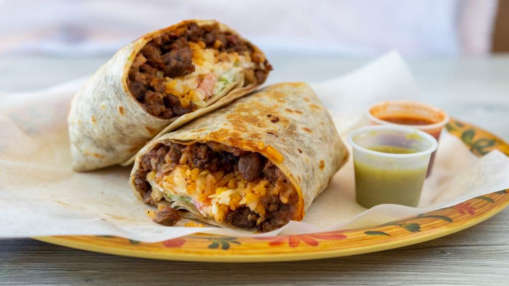 Burrito Ranchero · A burrito fit for a cowboy! Your choice of meat, cheese, beans, onions, cilantro, and a special tomatillo salsa.
