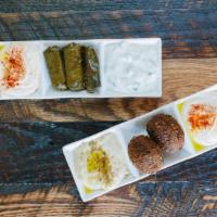 Mezze Sampler · A combination of hummus, baba ghanoush, falafel, dolma, and tzatziki.