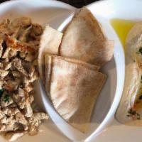Shawarma on Hummus · Hummus topped with a choice of chicken or lamb & beef shawarma, and pine nuts.