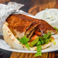 Gyro Wrap · Slow cooked gyros, with lettuce, onions, tomato and tzatziki.