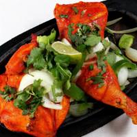 Tandoori Chicken · Chicken marinated in yogurt, ginger and garlic, then roasted in our clay oven.