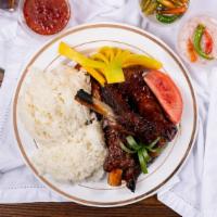 3 Pork Ribs Over Rice · Three grilled pork bbq ribs over rice slathered with our very own bbq sauce