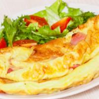 The California Omelette · Fresh eggs, peppers, tomatoes, ham, and creamy cheddar cheese. Served with a side of home fr...