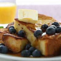 Blueberry French Toast · Sliced challah bread soaked in eggs and milk, then fried and topped with blueberries served ...