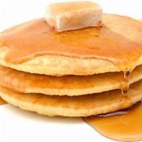 Original Buttermilk Pancakes · Three perfectly fluffy pancakes served with a side of butter and syrup.