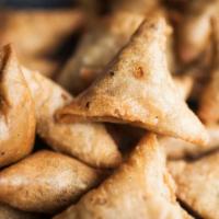 Cocktail Samosas · Crispy triangles filled with spicy potatoes and peas