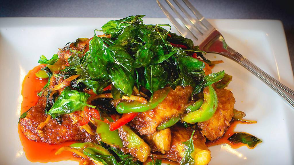 Spicy Catfish · Deep-fried de-boned catfish sautéed with bell pepper in red chili paste, topped with crispy basil leaves.
