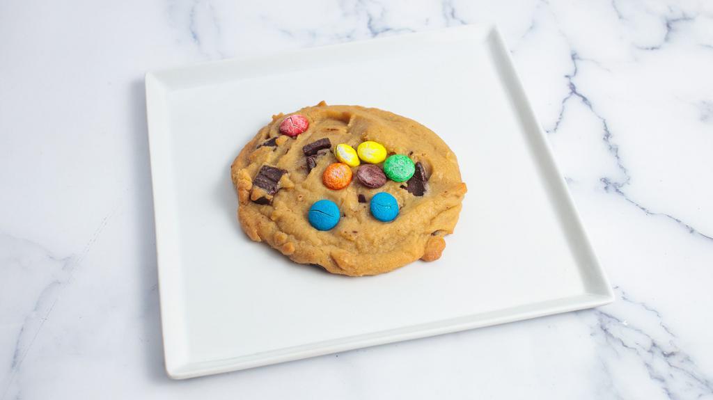M&M · Made from chocolate chunk cookie dough topped with Hershey's Kisses, semi sweet chunks and Milk chocolate chunks. Oversized Cookie.