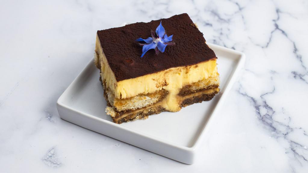 Tiramisu · A traditional Italian dessert consisting of alternating layers of imported mascarpone and ladyfingers delicately soaked in espresso with a hint of liquor.