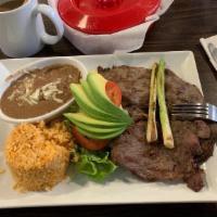 Carne Asada · Rice, refried beans,  cheese, side salad, avocado and sour cream.