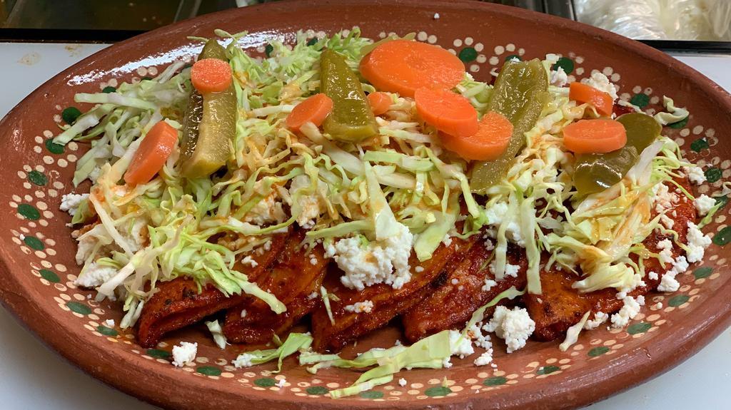 Meli Enchiladas · include: 5 enchiladas stuffed with potato , cooked with red sauce on top fresh cheese, cabbage and salsa