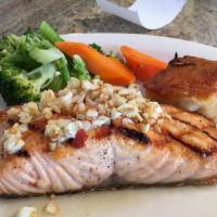 Grilled Salmon · Served with scalloped potatoes, and vegetables of the day.