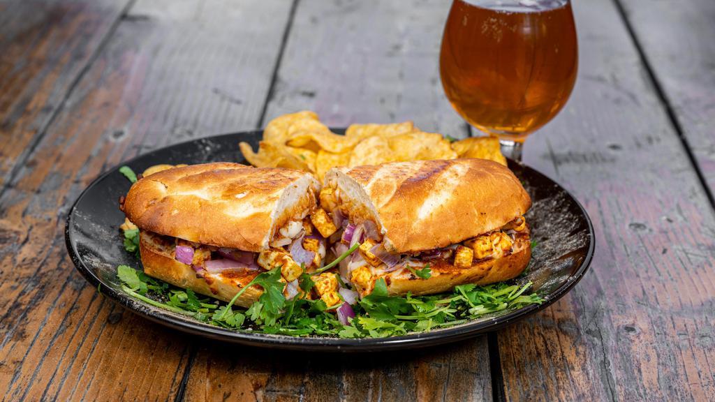 Chili Paneer Sandwich · Masala marinated paneer, red onions with spicy curry sauce and fresh seasoning.  Served on fresh baked bread that is hot and crispy!