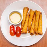 Shrimp Roll · Six pieces. Marinated shrimp with thai herbs wrapped with egg roll skin.