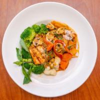 Salmon Curry · Grilled filet of salmon topped with panang curry sauce, mushrooms, and basil. Served with st...