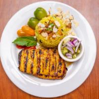 Chicken with Coconut Rice · Grilled marinated chicken breast with fried coconut rice, raisins and sliced almonds. Served...