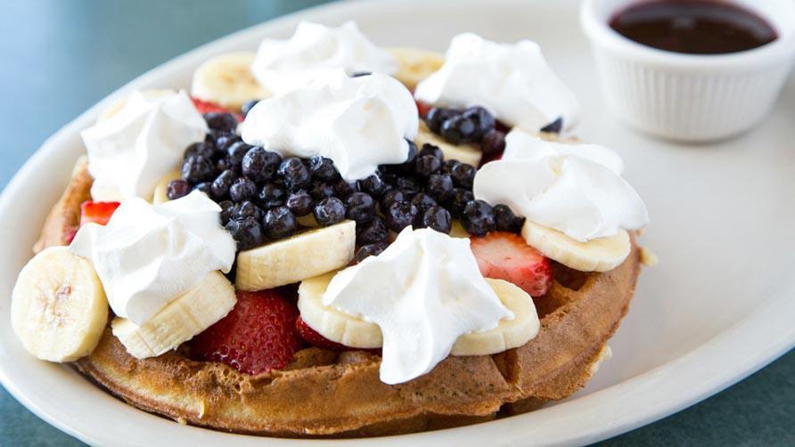 Bay Watch Waffle · Waffle topped with sliced bananas, strawberries, blueberries, and whipped cream.