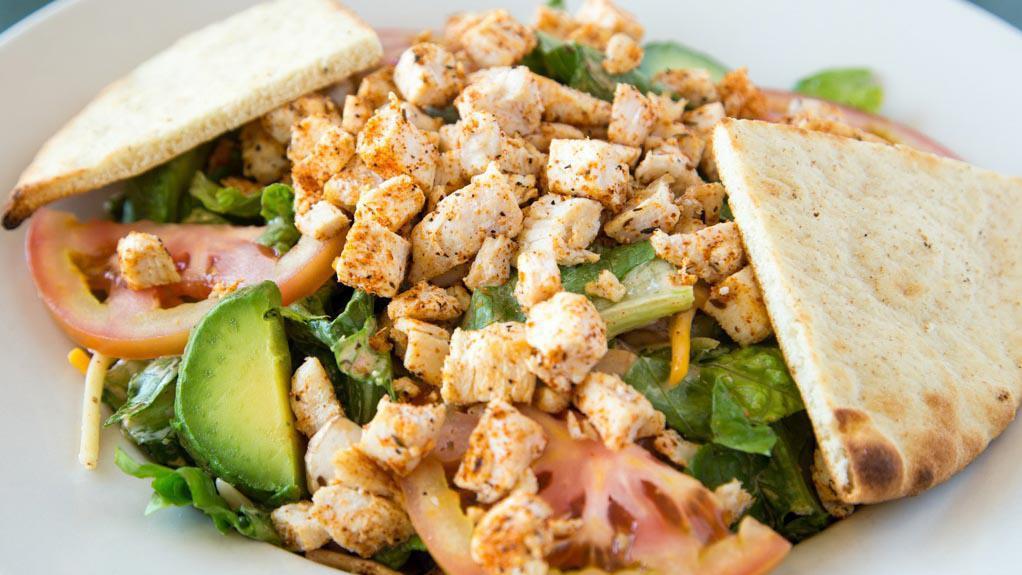 Santa Fe Salad · Fresh greens, mushrooms, tomatoes, cheeses, and avocado all tossed in our own Santa Fe dressing. Topped with Cajun chicken breast and croutons. Addictive. . . Beware!